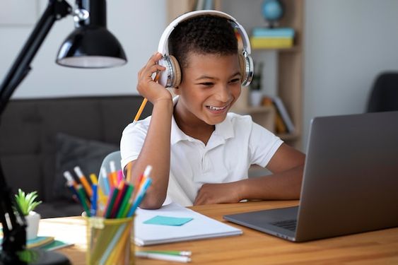 A smiling student looking at screen